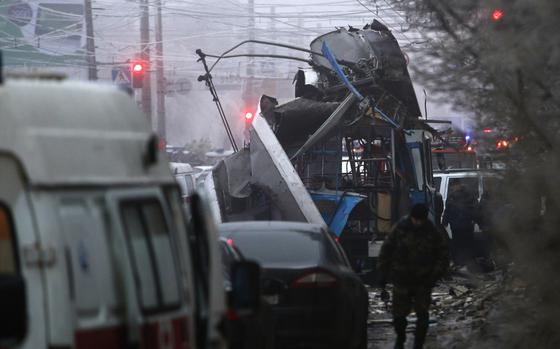 FILE - Experts and police officers examine a site of a trolleybus explosion, in Volgograd, Russia, Monday, Dec. 30, 2013. The attack on a Moscow concert hall in which armed men opened fire and set the building ablaze, killing over 130 people, was the latest in a long series of bombings and sieges that have unsettled and outraged Russians during Vladimir Putin’s nearly quarter-century as either prime minister or president.  (AP Photo/Denis Tyrin, File)