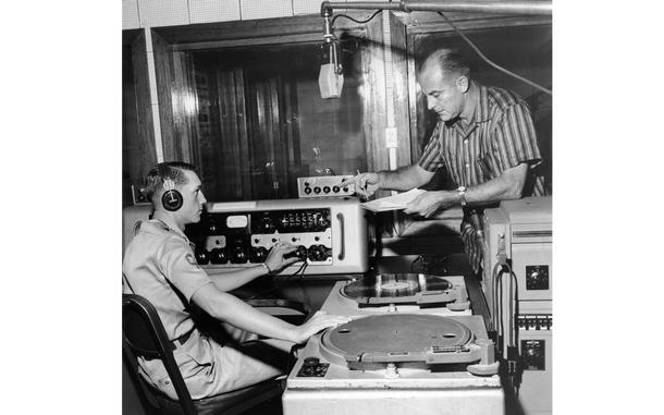 [PUBLISHED CAPTION: Radio production is discussed in the control room by SP4 Larry Renaud and James Mayall. 09/16/1959]; Apart from radio programs, AFKN also produces and airs television programs through AFKN-TV. Tuesday, September 15th, 1959 marked the 2nd anniversary of AFKN-TV programming in Korea. [cg]