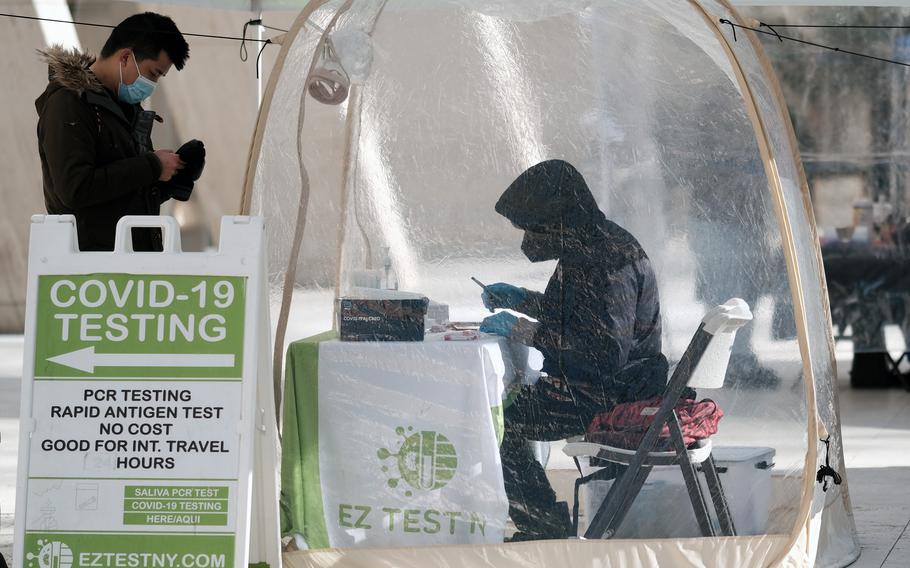 A person visits a COVID-19 testing site along a Manhattan street on Jan. 21, 2022, in New York City. 