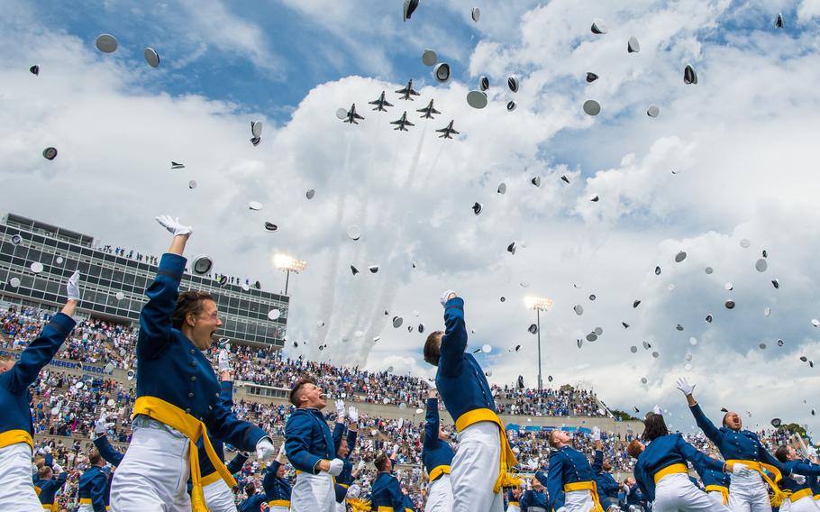U.S. Air Force Academy Class of 2021 graduates toss their service caps as the U.S. Air Force Thunderbirds fly overhead during the Academy’s graduation ceremony in Colorado Springs, Colo., May 26, 2021.