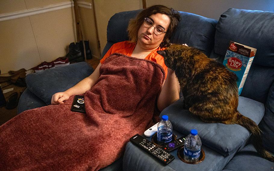Violet Rin rests at a home after a brief shopping trip. After new Florida laws affecting transgender people went into effect, she stopped going out as much.