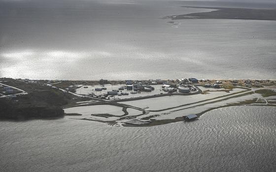 A Coast Guard Air Station Kodiak aircrew flies over Golovin, Alaska, to assess damage to houses and facilities, September 18, 2022. Coast Guard crews are responding to impacted communities following a historic storm, Typhoon Merbok, that hit Alaska's western coast. U.S. Coast Guard photo by Petty Officer 3rd Class Ian Gray.