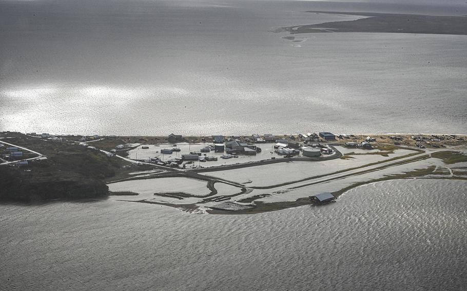 A Coast Guard Air Station Kodiak aircrew flies over Golovin, Alaska, to assess damage to houses and facilities, September 18, 2022. Coast Guard crews are responding to impacted communities following a historic storm, Typhoon Merbok, that hit Alaska’s western coast.  