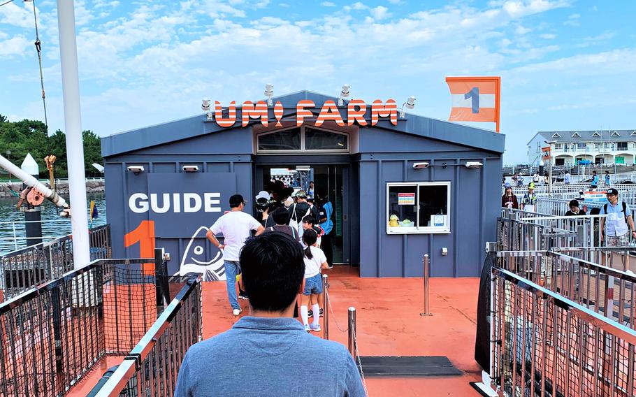 Visitors walk down a dock to Umi Farm, where they can catch their own fish to eat at Yokohama Hakkeijima Sea Paradise near Yokohama, Japan, Oct. 1, 2023.