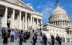 Members of Congress and staff stand for a moment of silence for the 9/11 victims and families on Sept. 11, 2020, at the Capitol in Washington. On Monday, members of Congress will mark the 20th anniversary of the attacks. MUST CREDIT: Washington Post photo by Demetrius Freeman.