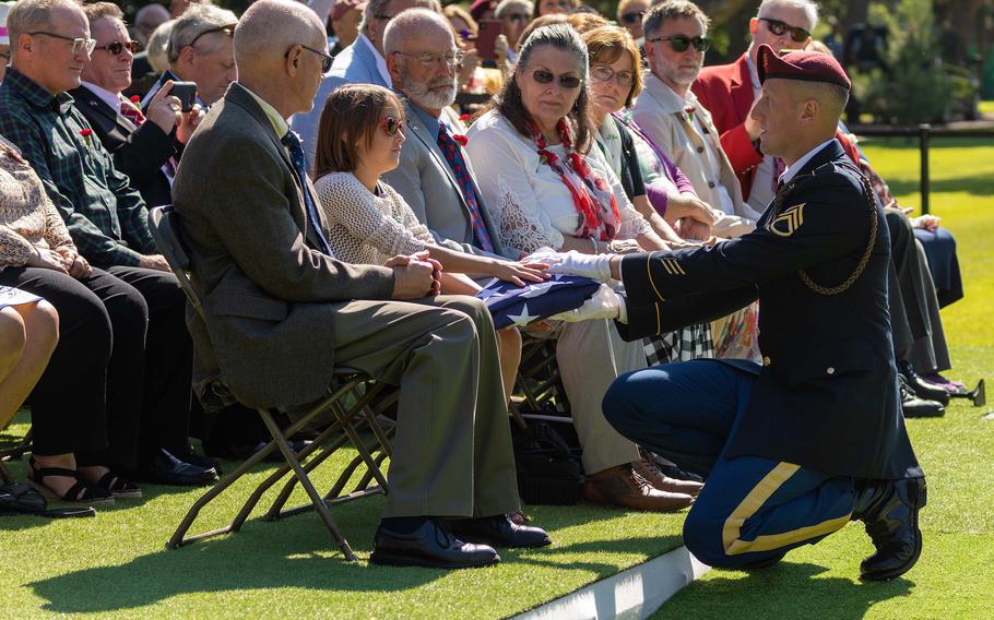 Sgt. 1st Class Ivan Sehovic, 173rd Infantry Brigade Combat Team, presents the American flag to family members during a burial ceremony for U.S. Army Air Forces 2nd Lt. William J. McGowan at Normandy American Cemetery, France, on July 9, 2022.