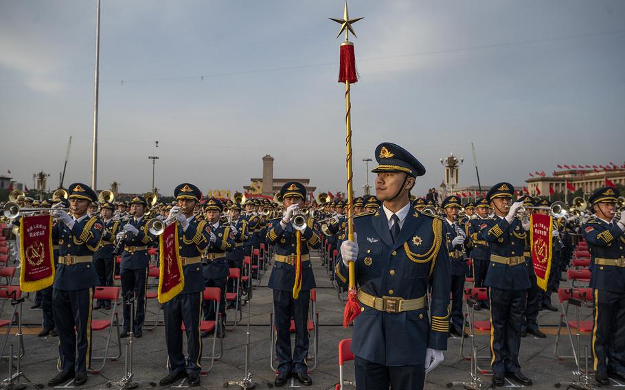 A Chinese military band conductor stands in front of band members at a ceremony marking the 100th anniversary of the Communist Party on July 1, 2021, at Tiananmen Square in Beijing, China.
