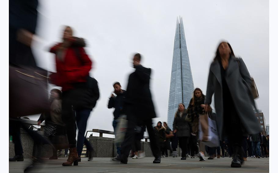 Commuters cross London Bridge in the City of London, UK, on March 21, 2023. 