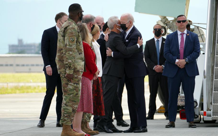 President Joe Biden embraces U.S. Ambassador to Japan Rahm Emanuel afer landing at Yokota Air Base, Japan, Sunday, May 22, 2022. 