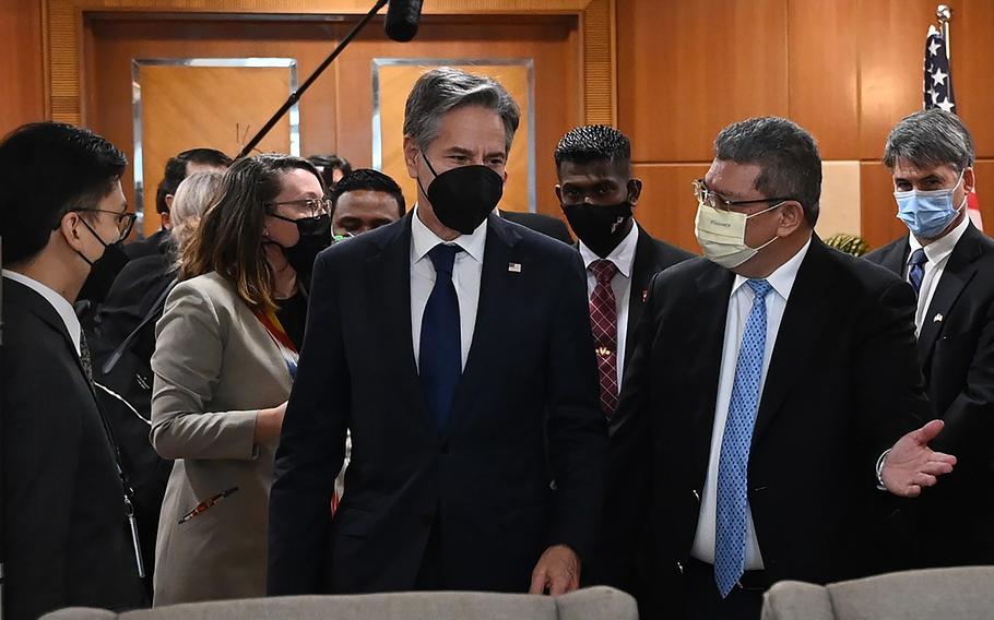 In this photo released by Malaysia's Ministry of Foreign Affair, U.S. Secretary of State Antony Blinken, center, is welcomed by Malaysian Foreign Minister Saifuddin Abdullah, right, at foreign ministry in Putrajaya, Malaysia, Wednesday, Dec. 15, 2021. 