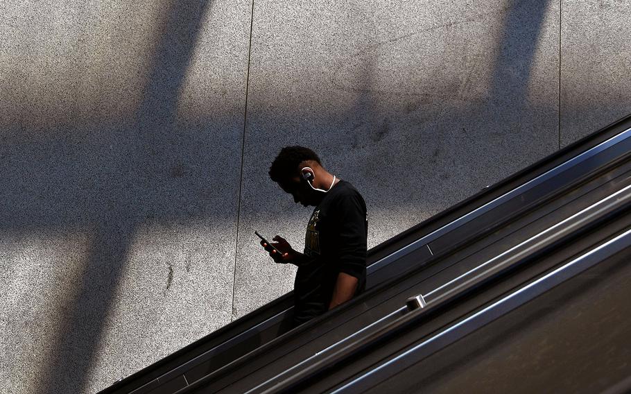 A man on his phone at the Eastern Market Metro station in 2018.