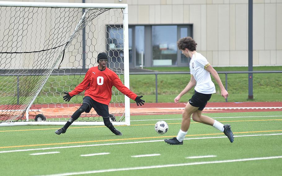 Spangdahlem goalkeeper Isaiah Riley spreads out to try to stop Alconbury midfielder Leo Politis during the second half of a March 16, 2024, game at Spangdahlem High School in Spangdahlem, Germany. Politis scored on the play.