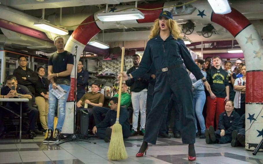 Then-Petty Officer 3rd Class Joshua Kelley performs during a Morale, Welfare and Recreation lip sync battle aboard the aircraft carrier USS Ronald Reagan, Nov. 29, 2017.