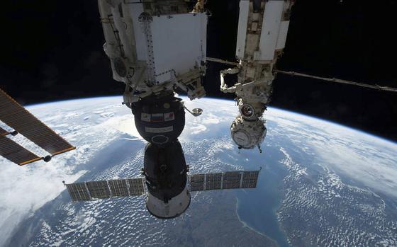The photo provided by NASA shows the Soyuz MS-22 crew ship pictured on Oct. 8, 2002, in the foreground docked to the Rassvet module as the International Space Station orbited 264 miles above Europe. In the background, is the Prichal docking module attached to the Nauka multipurpose laboratory module. Russian space corporation Roscosmos said Wednesday, Jan. 11, 2023 that it will launch a new spacecraft to take some of the International Space Station's crew back to Earth after their capsule was damaged and leaked coolant.(NASA via AP)