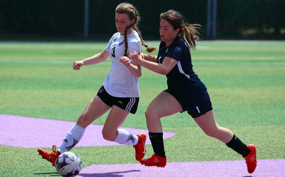 Osan's Grace Williams (1) defends against Gyeonggi Suwon's Summer Chilson during Saturday's Korea postseason girls soccer tournament match. The Cougars won 4-3 in penalties, but later lost the fifth-place match 3-0 to Yongsan International-Seoul.