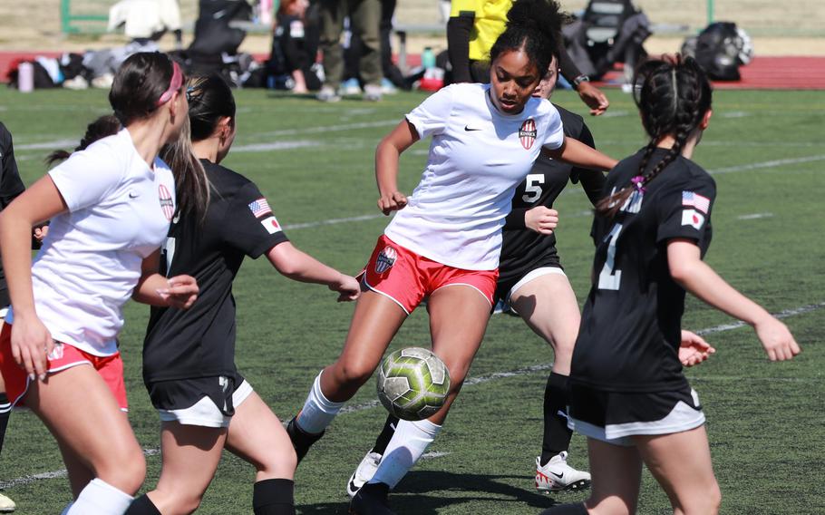 Nile C. Kinnick’s Alyssa Staples tries to play the ball through traffic against Zama during Saturday’s DODEA-Japan girls soccer match. The Red Devils won 6-0.