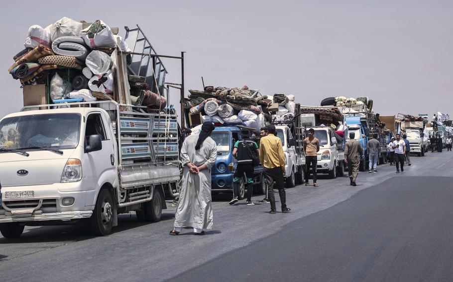 Pickup trucks carrying families from Syria.