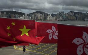 FILE - Chinese and Hong Kong flags are hanged to celebrate the 25th anniversary of Hong Kong handover to China, in Hong Kong, Friday, June 17, 2022. Hong Kong's government on Saturday, May 27, 2023 slammed rights group Amnesty International's accusation over a missing Uyghur student as "groundless," and said that government records showed that the student had not entered or been refused entry to Hong Kong. (AP Photo/Kin Cheung, File)
