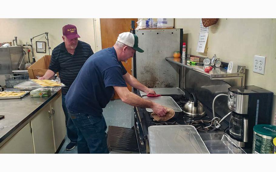 Chad Wright places a pan of pasta on the stove after he took it out of the oven for April’s veterans lunch at Easthampton Congregational Church. Wright is a veteran and associate director for operations at Building Bridges. Holding the garlic bread is Ken Blanchard, Air Force veteran and member of the Easthampton Rod and Gun Club, sponsor of the April lunch. 