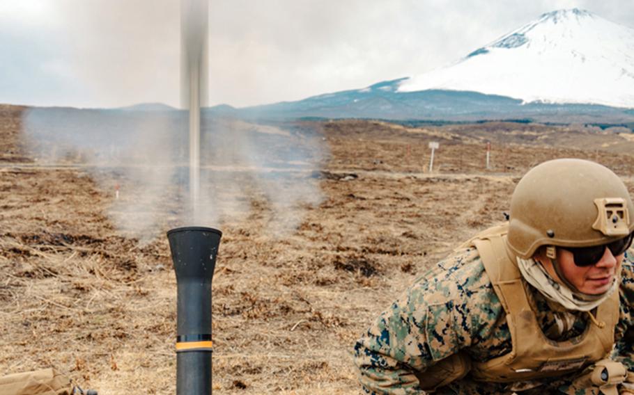 Marine Cpl. Darren Zavala, a mortarman with the 31st Marine Expeditionary Unit, fires an 81mm mortar at Combined Arms Training Center Camp Fuji, Japan, March 23, 2022.