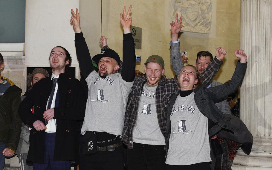 From left, Sage Willoughby, Jake Skuse, Milo Ponsford and Rhian Graham celebrate outside Bristol Crown Court, Bristol, England, Wednesday Jan. 5, 2021.