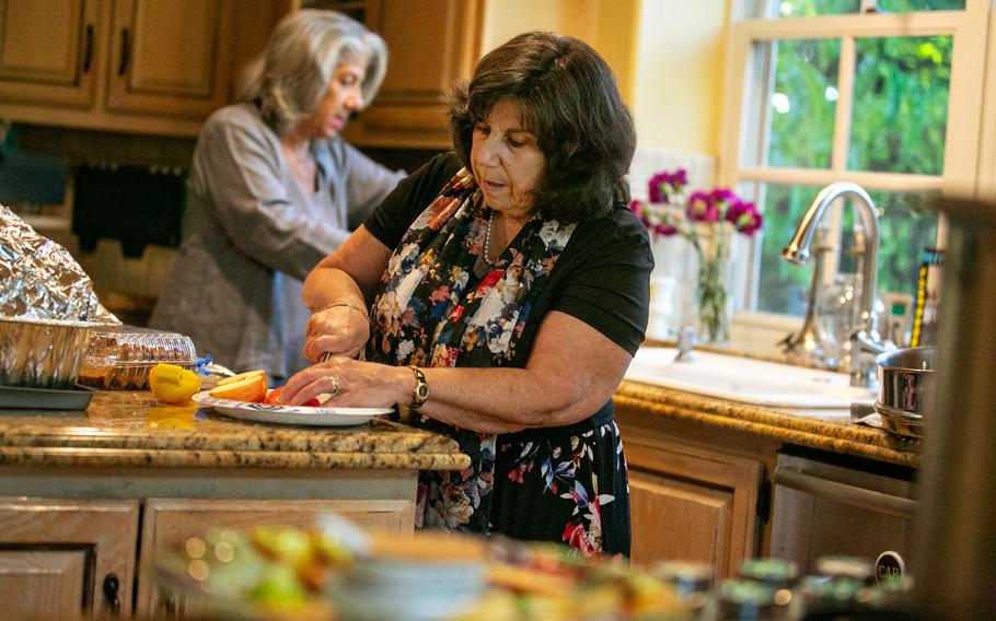 Pamela Taylor, an evacuee of the Caldor fire in South Lake Tahoe, prepares apples and honey for the Jewish New Year in Calabasas, Calif. 