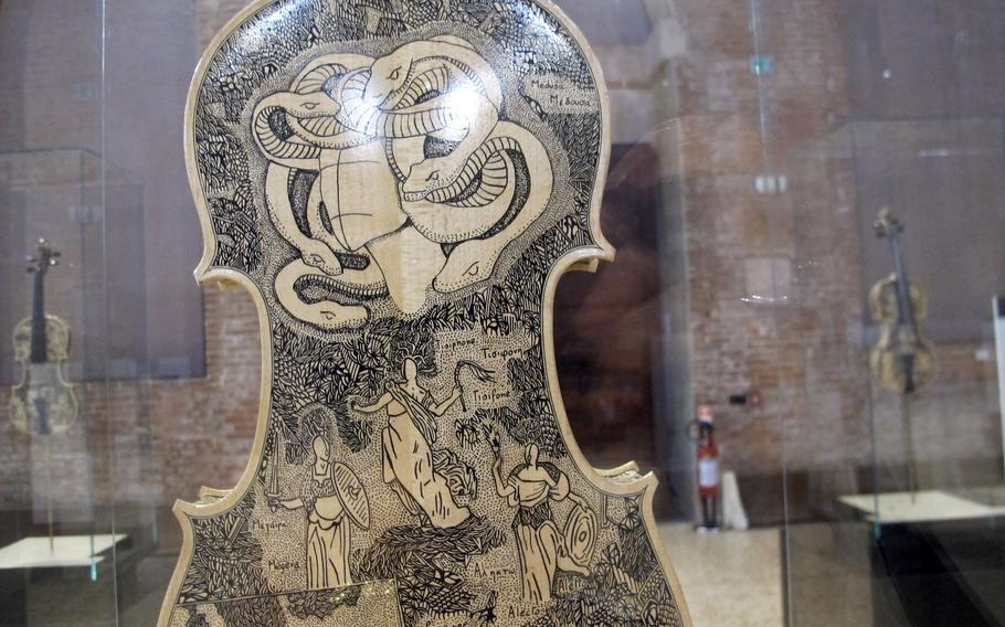 Snakes in hell are shown on one of 33 violins painted with scenes from the great medieval Italian poet Dante's Divine Comedy. The exhibit is at the Palladian Basilica in Vicenza, Italy through Aug. 31.