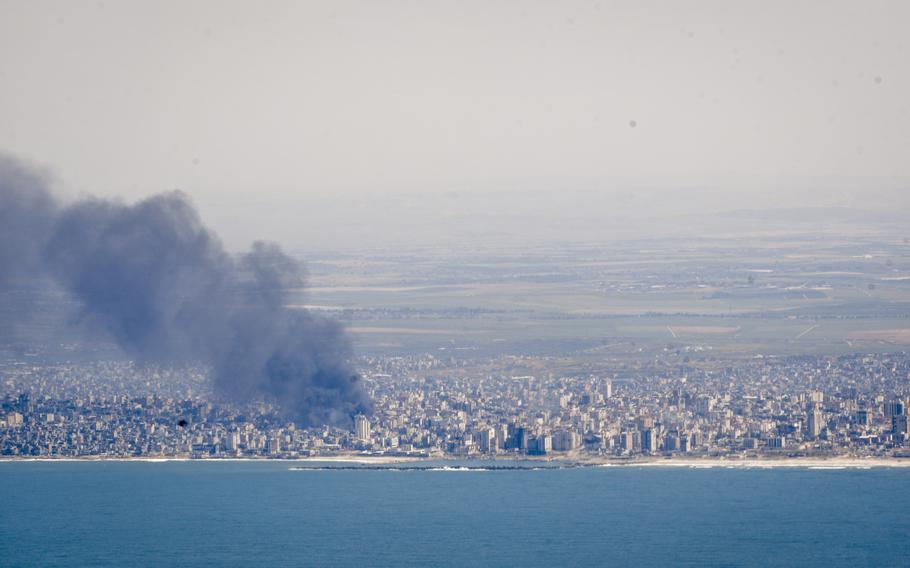 A plume of black smoke billows from near the Al Shifa hospital in Gaza City as seen from the cockpit of a U.S. Air Force C-130 cargo plane approaching for a humanitarian airdrop mission on Wednesday, March 20, 2024. 