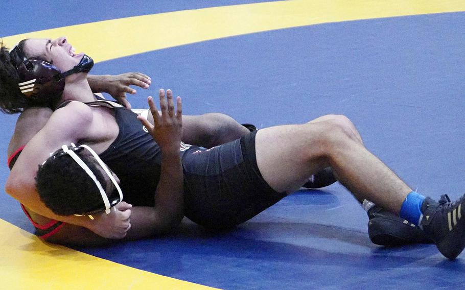 Matthew C. Perry's Jayden Valverde tries to lock in a head-and-arm on E.J. King's Kaidence Farley at 145 pounds during Saturday's Christian Academy Japan Invitational Tournament.