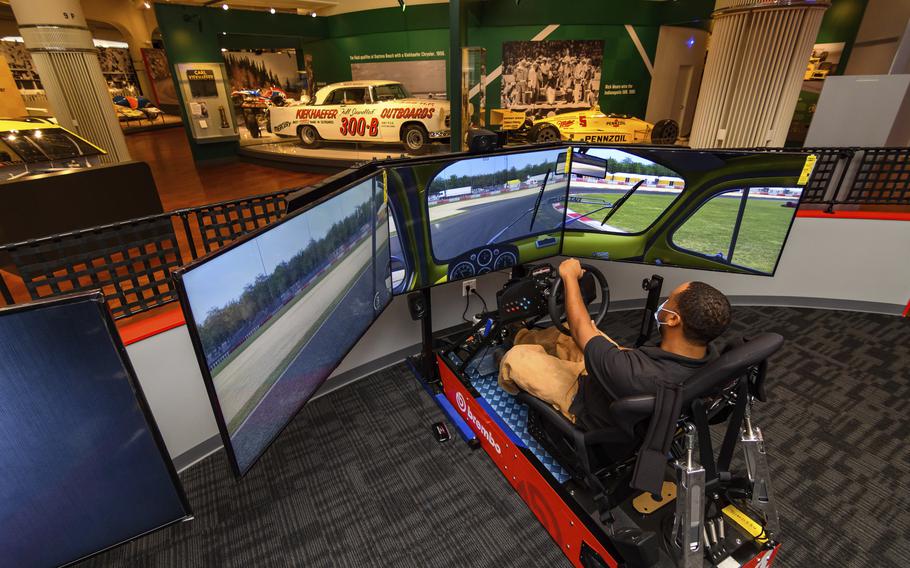 In this image provided by the The Henry Ford, a person tries the auto racing simulator, part of the Driven To Win exhibit at the The Henry Ford Museum in Dearborn, Mich. The “Driven to Win” exhibit took more than a decade from concept to its opening earlier this year. 