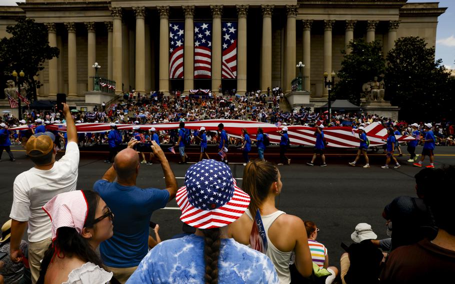 A giant American flag is marched down Constitution Ave during the Fourth of July parade in downtown D.C.