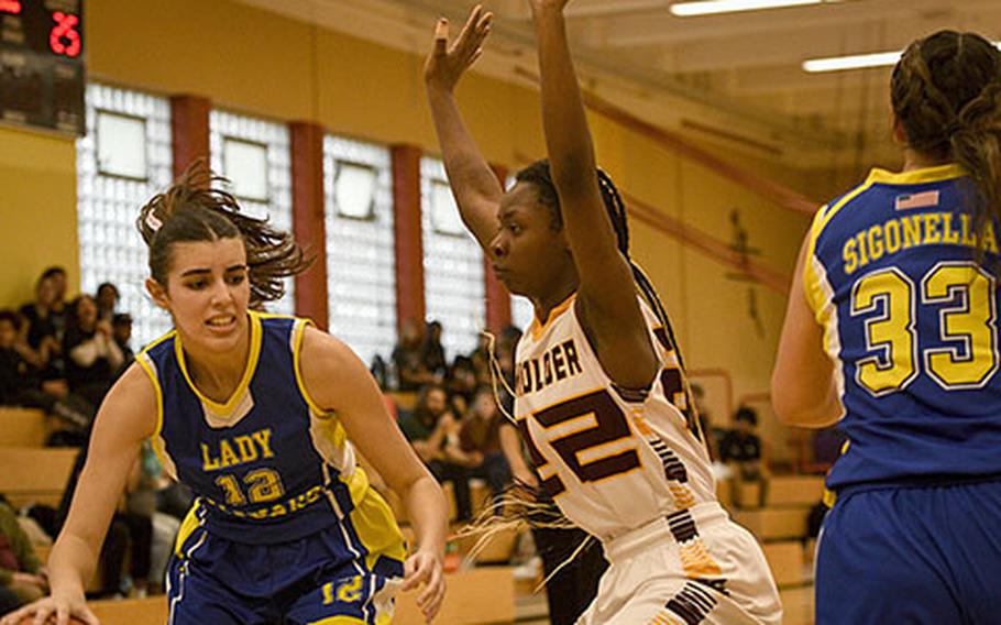 Sigonella's Fabiola Mercado-Rodriguez drives as Baumholder’s Adrianna Lopez defends during a DODEA-Europe Division III basketball semifinal game Feb. 17, 2023, in Baumholder, Germany.