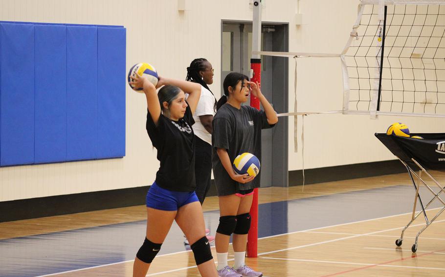Players practice volleyball.