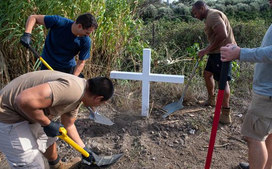 Seabees from Naval Air Station Sigonella on the Italian island of Sicily install a roadside cross as a memorial Nov. 3, 2023.