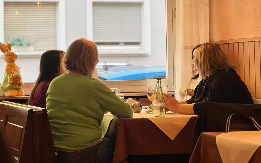 Guests wait for their food at one of only two window tables at Zur Pfaffschenke in Kaiserslautern, Germany. Space in the German restaurant is limited and seats fill quickly each night.