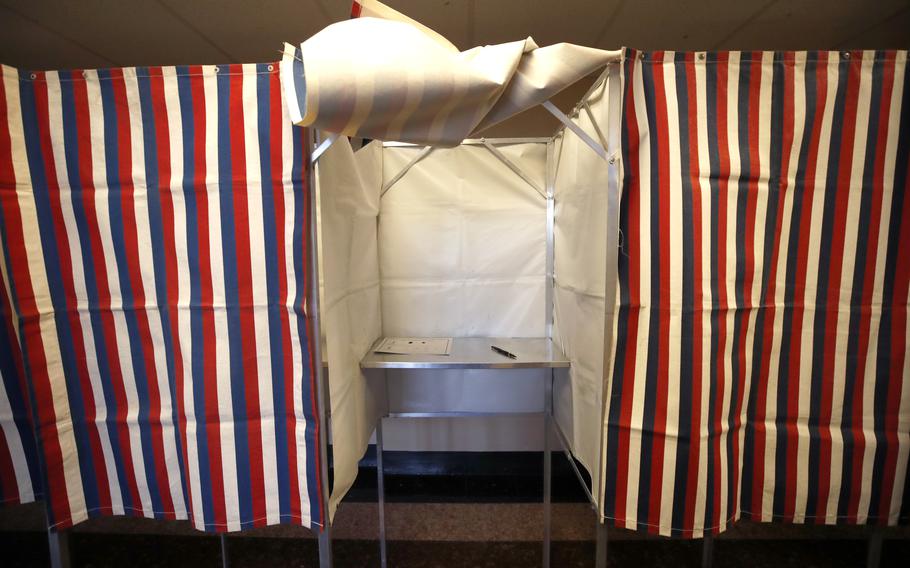 A booth is ready for a voter, Feb. 24, 2020, at City Hall in Cambridge, Mass., on the first morning of early voting in the state. U.S. intelligence officials think Russian President Vladimir Putin may use the Biden administration’s support for Ukraine as a pretext to order a new interference campaign in American politics. That’s according to a new assessment described to The Associated Press by several people who spoke on condition of anonymity. 
