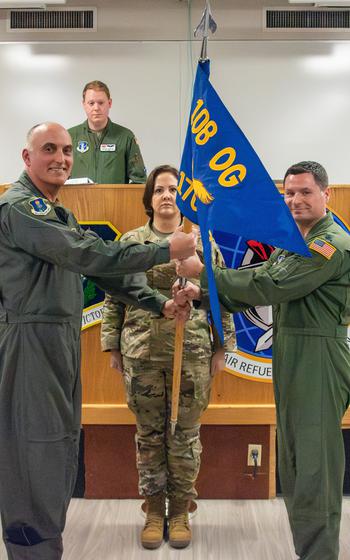 Lt. Col. Matthew Secko, 170th Air Refueling Squadron commander, at right, receives the unit guidon from Col. William Liess, 108th Operations Group commander, at left, during the 170th assumption of command ceremony Thursday, March 7, 2024, at Joint Base McGuire-Dix-Lakehurst, N.J. Secko is the first commander for the newly activated 170th Air Refueling Squadron.