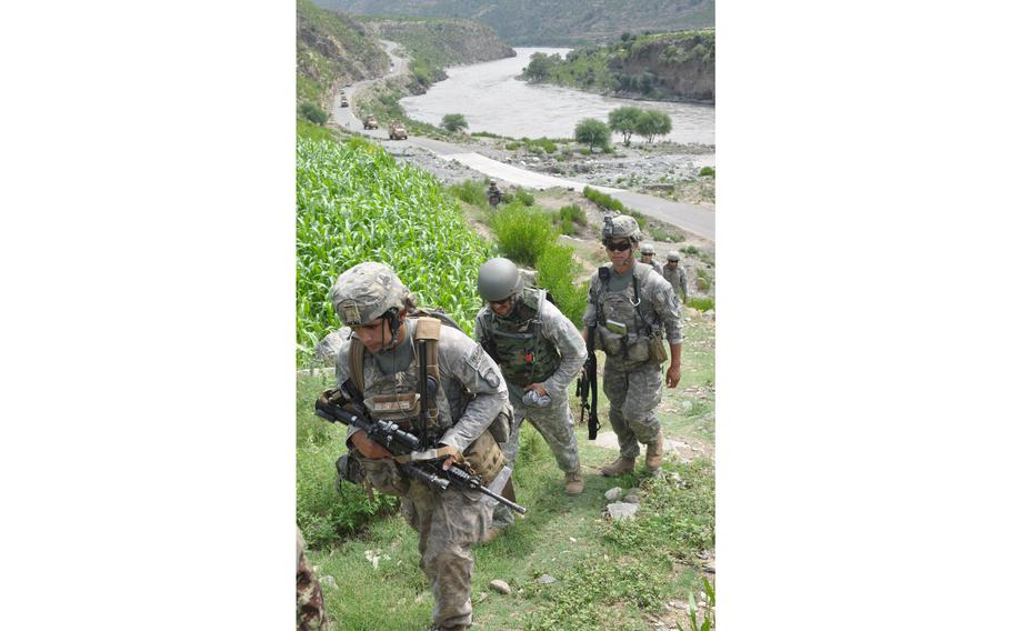 Soldiers from COP Monti climb up a mountain beside the main road along the Kunar River at Spin Kay on Aug. 2, 2010. The area is known for insurgent attacks on the U.S. forces that killed 9 U.S. soldiers in a month.