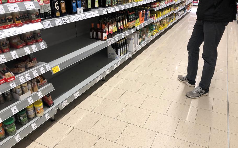 Shelves at a Rewe grocery store in Darmstadt, Germany, on April 4, 2022, are devoid of sunflower oil and canola oil. Since the start of the Russia-Ukraine war, Hamsterkaeufe, the German word to describe panic buying or hoarding, has set in, and demand for cooking oil and flour has outstripped supply.