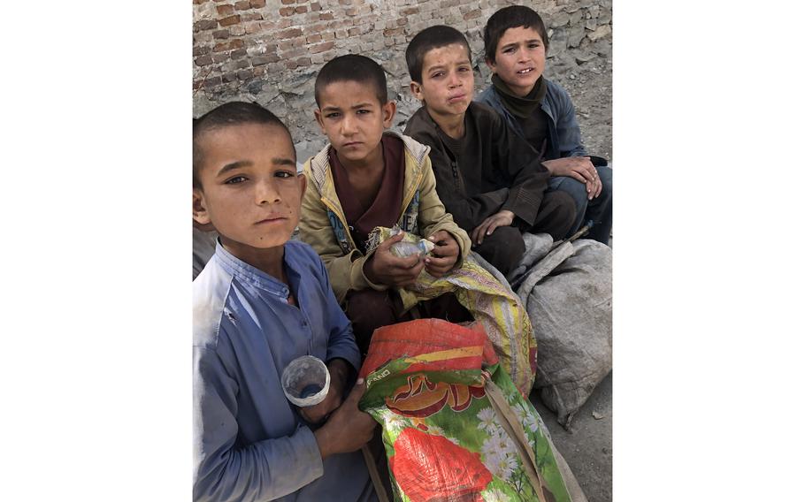 Four young boys take a break from scavenging for cans and bottles in Kabul on April 14. 