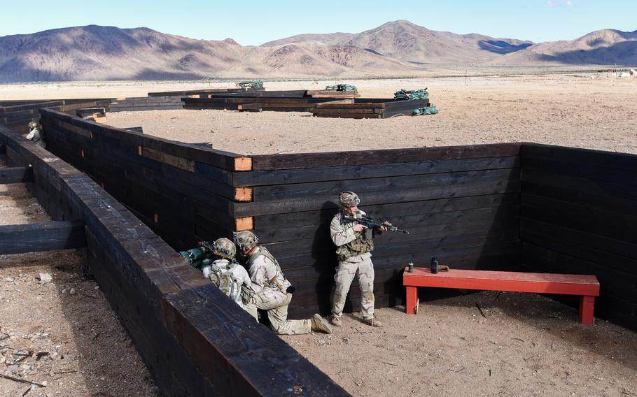 3rd Infantry Division soldiers, serving as part of the opposing force, man fighting positions inside a trench during a force-on-force battle at the Army’s National Training Center at Fort Irwin in California’s Mojave Desert on Feb. 26, 2023. 