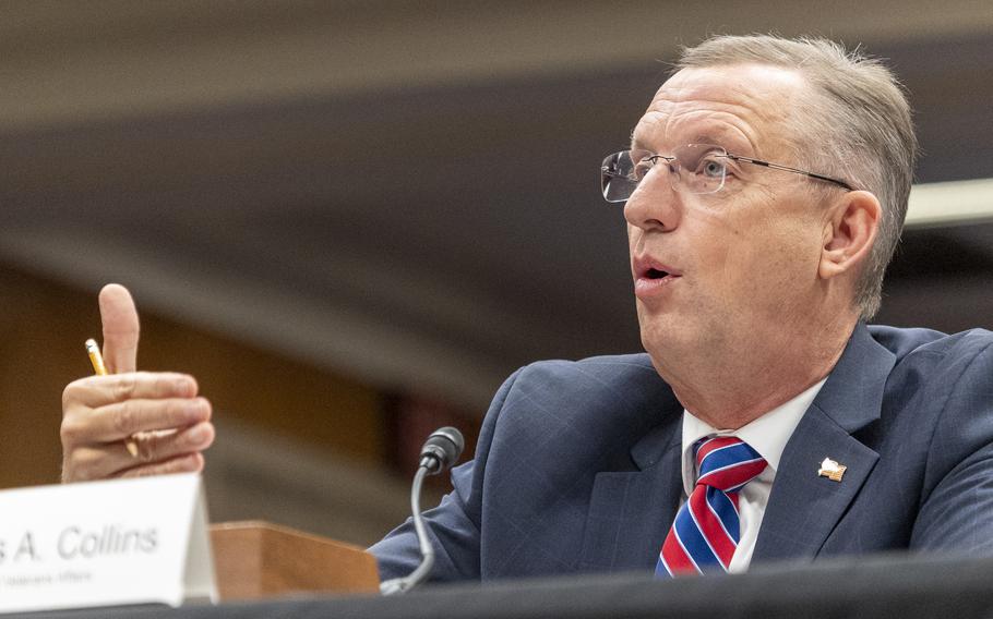 Doug Collins speaking while seated with one hand raised in gesture.