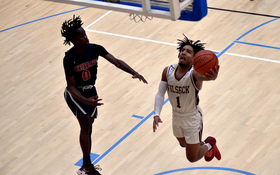 Vilseck senior Brandon Goins goes up on the drive while Lakenheath guard Gideon Toure defends during pool-play action of the DODEA European basketball championships on Feb.14, 2024, at the Wiesbaden Sports and Fitness Center on Clay Kaserne in Wiesbaden, Germany.