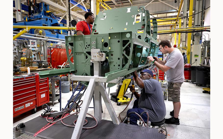 Workers assemble parts on the lower mid section of a Boeing F/A-18 Super Hornet fighter jet at the St. Louis assembly line on Aug. 10, 2022.