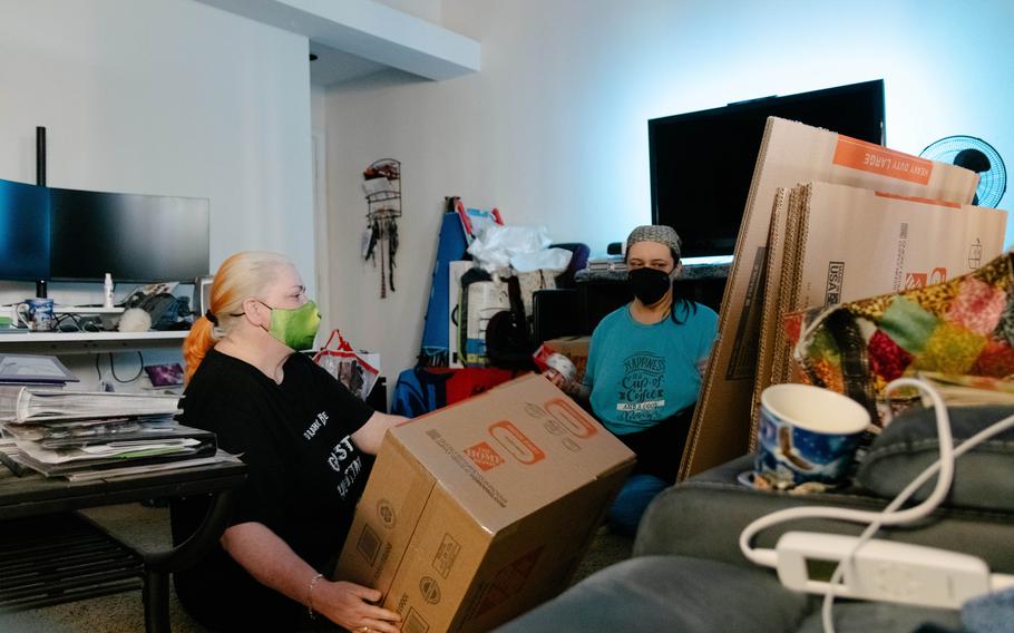 Shadow LaMere and Brandi Kalinowski packing things up in their living room before they move out of their Austin apartment. Their rent went up 43% this year. 
