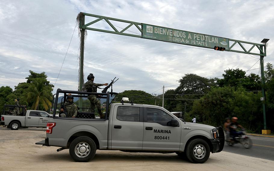 Members of the Mexican navy stand guard at the entrance of Petatlan, in the state of Guerrero, Mexico, on Jan. 7, 2024, a day after five people were killed and 20 injured in an attack by unknown gunmen during a cockfighting event. 