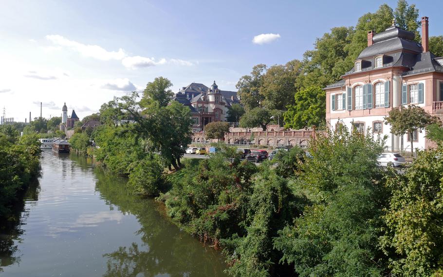 A view down the Main River from a pedestrian bridge in the Hoechst section of Frankfurt. At right is a pavilion of the Bolongaro Palace. In the background is the tower of Hoechst Palace and at far left, the industrial plants that the area is best-known for.