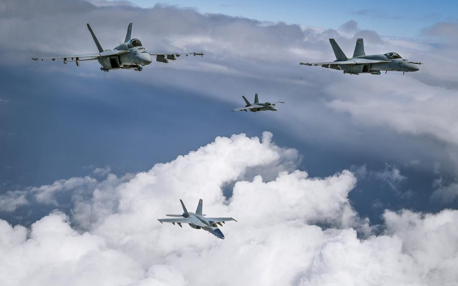 F/A-18E Super Hornets from Strike Fighter Squadron (VFA) 136 “Knighthawks” fly in formation during a photo exercise over California.