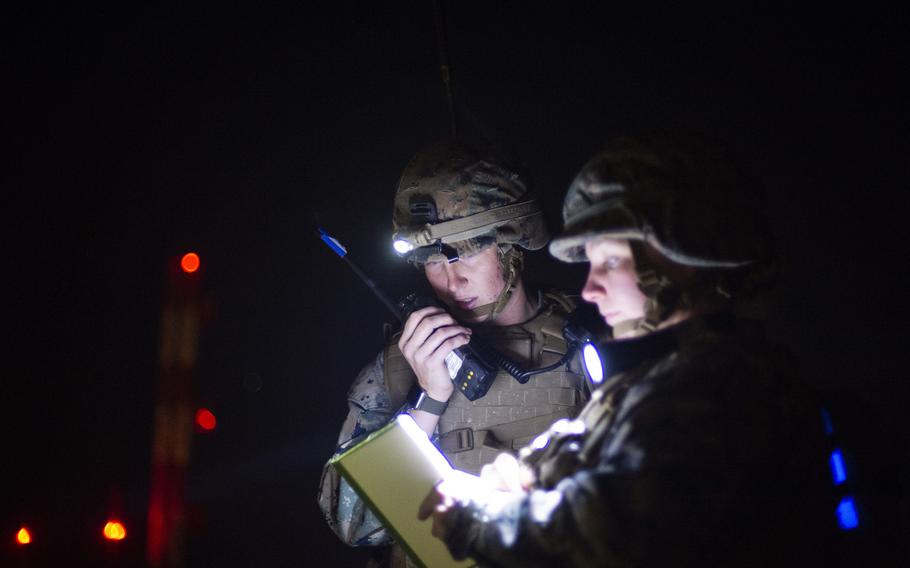 Marine Sgt. Aubrey Larsen, the Forward Aviation Combat Engineering platoon sergeant, radios in a damage report after a mock attack on the flight line at Marine Corps Air Station Iwakuni, Japan, Oct 28, 2021.
