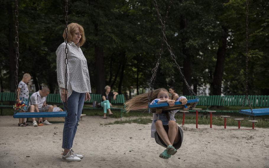 Vasylyna Sirenko, 6, with her grandmother at a playground in Lviv, Ukraine on July 30, 2022.
